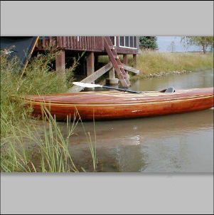 Short stable cedar kayak on a river